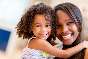 adoptive mother and daughter hugging
